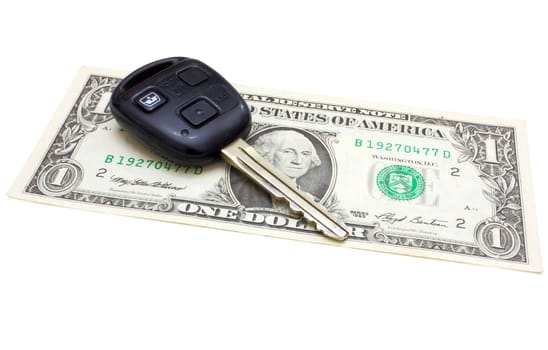 Car keys over the one dollar banknote isolated on white background.