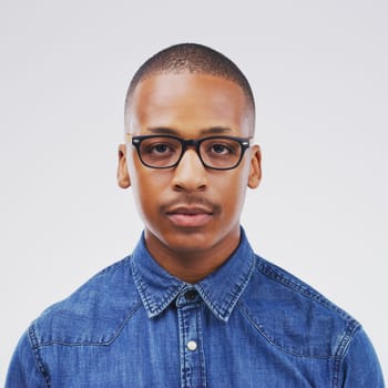Portrait, African and man in white background in studio with serious, face and glasses in mockup space. Black, male person and trendy, eyewear and isolated in backdrop for fashion, style and model.