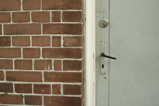 Brick wall, door and building in urban area for design, texture and architecture for construction. Concrete, pattern and vintage structure for development, exterior and maintenance in old town