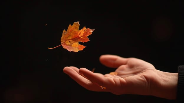 A person holding a leaf in their hand with the wind blowing it