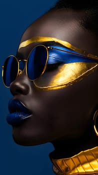 A close up of a womans face with sunglasses and blue and gold makeup, showcasing her stylish eyewear and eyebrow
