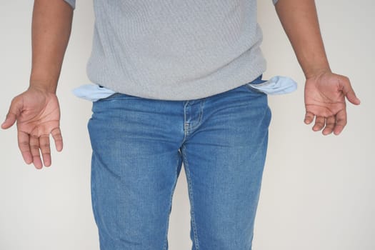 young man shows empty pant pocket with copy space .