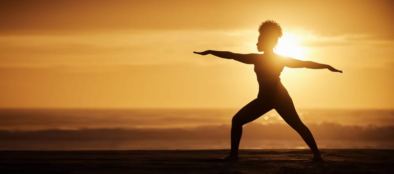 Yoga, sunset and silhouette of woman in warrior pose for exercise, fitness or meditate at beach on mockup. Virabhadrasana, ocean and girl in nature for stretching, wellness and healthy body in summer.