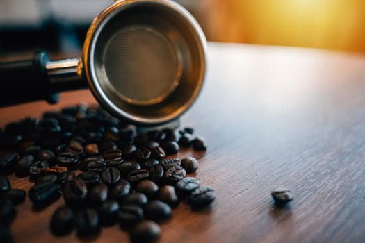 Coffee beans and tamper on a modern table. Metal equipment for espresso preparation. Organic beans restaurant setting with mocha cup gourmet refreshment.