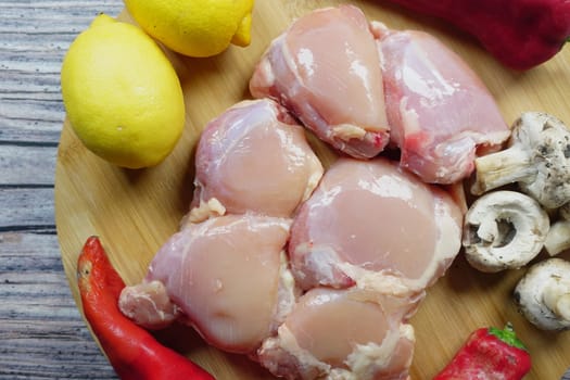 raw breast chicken meat and vegetables on a chopping board ,