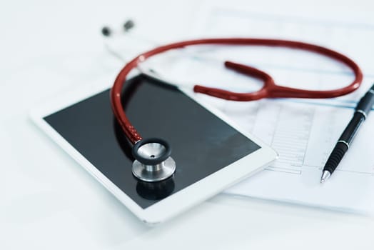 Hospital, documents and tablet with stethoscope on desk for medical website, telehealth and research. Healthcare, cardiology and digital tech, equipment and clipboard for online consulting service.