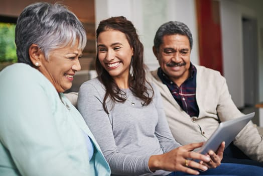 Senior parents, woman and tablet in living room for connection or bonding with tech. Family, home and mature people with young, female person and happy for togetherness on couch in community.