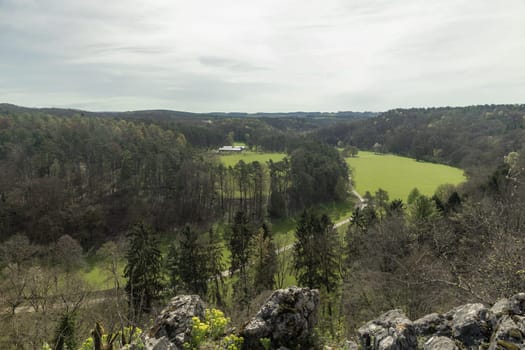 Beautiful panoramic view from the height of a mountain at a nature reserve in Rochefort, Belgium, on a cloudy spring day, close-up side view.