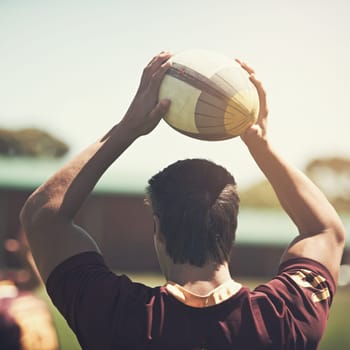 Athlete, game and rugby ball on field for training, workout and exercise in summer for fitness. Sport, strong man and wellness for challenge, collaboration and back of professional college team