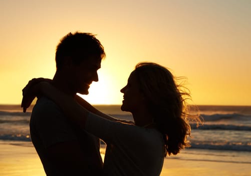 Couple, love and smile at beach with sunset for date or summer holiday and bonding in Florida. Relationship, silhouette and romance together as soulmate with travel, hug and vacation for honeymoon.