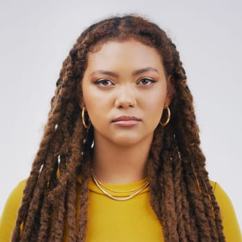 Annoyed, bored and frustrated with serious black woman in studio isolated on white background. Braids, disappointed and moody with face of overworked young person feeling burnout from fail or mistake.