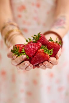 Bunch , strawberries and woman hands as a vegetarian for healthy, organic and balanced diet by eating nutritious snacks. Person, fresh and natural ingredients with vitamin from farming plantation.