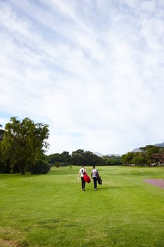People, ready and golf course for professional sport and walking on grass for training with mockup on field. Athlete, talking and friends with golfing equipment for game and together for exercise.