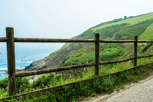 path with wooden fencing along the Atlantic Ocean, Northern Route Basque Country.