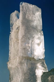 Rectangular ice sculpture block against the sky.