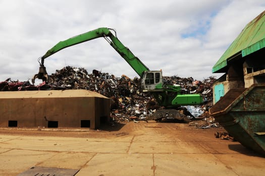 Scrap metal being recycled in junkyard. Ecological concept, metal recycling.