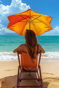 A woman relaxes under an umbrella on a sandy beach facing the ocean.