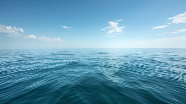 A large body of water with a few clouds in the sky