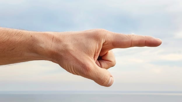 A man pointing his finger at the camera with a cloudy sky in background