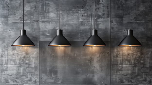 Three black lamps hanging from a wall with three lights on