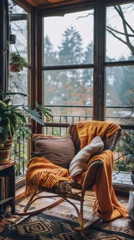 A rocking chair in a room with large windows and plants