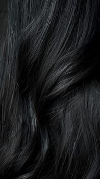 A close up of a woman's hair with long black strands