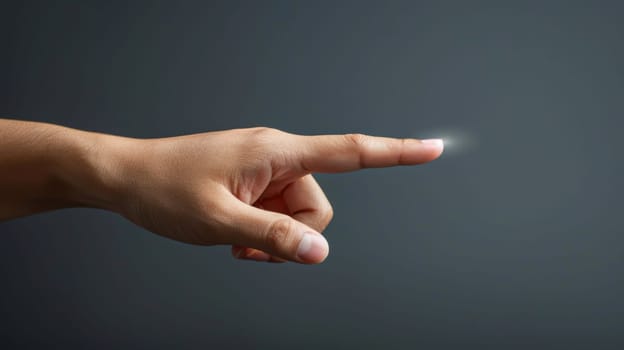 A hand pointing at something with a light coming from it