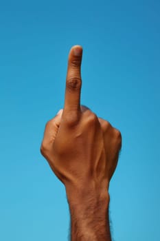 A man's hand is up in the air with a finger pointing