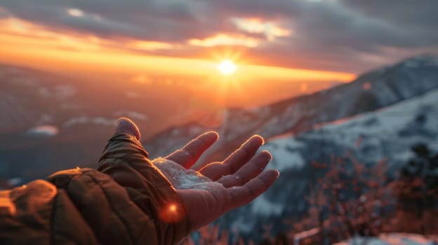 A person holding out their hand to receive snow from the sky