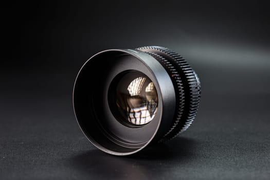 Professional black vintage camera lens, prominently displayed, Helios branding, intricate light reflections, essential tool for photographers, isolated on a dark backdrop.