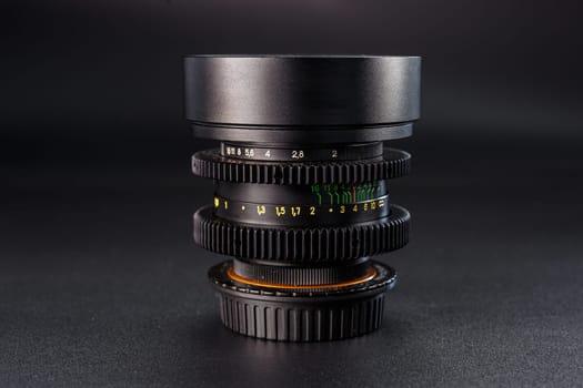 Detailed camera lens stack with visible aperture numbers, focus settings for photography experts, vintage design, precision tool on dark texture