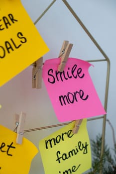 SMILE MORE self care goal on Action board new year's resolutions on colorful sticky notes. Making promises for new year, setting goals. Dream year motivation