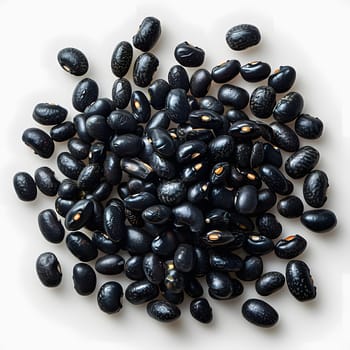 A pile of black beans, a nutrientrich superfood and natural food ingredient commonly used in Latin American cuisine, sits on a white surface