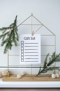 Preparation for winter holidays. GIFT LIST text on paper note. Celebration gifts and presents preparing Natural zero waste homemade Christmas decor. Happy new year concept.