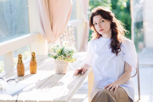 Portrait of a Russian young girl sitting on a chair