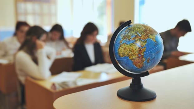 A globe of the world in a school classroom during a lesson