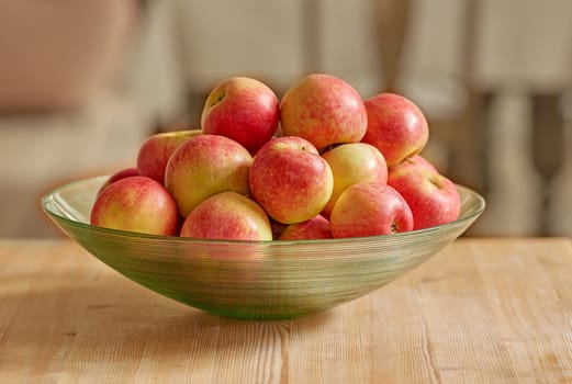 Bowl of red apple, nutrition and diet with health, wellness and organic vitamins and snack. Fruit, plant and harvest with botanical produce, horticulture and natural vegetation on kitchen food.