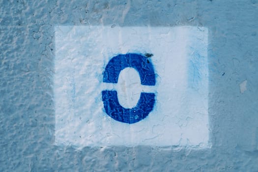 Number zero painted on a blue wall in a rectangle. High quality photo