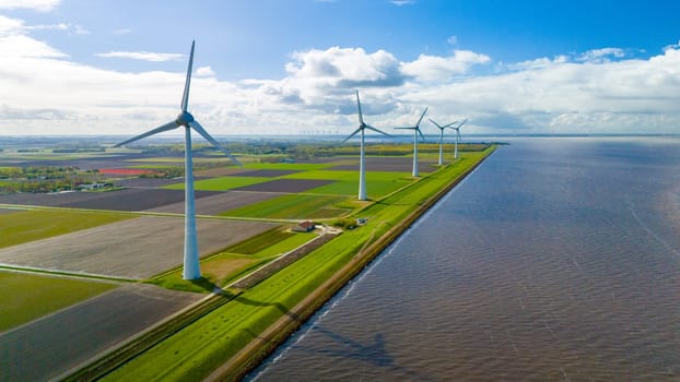 A picturesque scene of windmill turbines gracefully spinning in a large body of water in the Netherlands during the vibrant Spring season. windmill turbines in the Noordoostpolder Netherlands