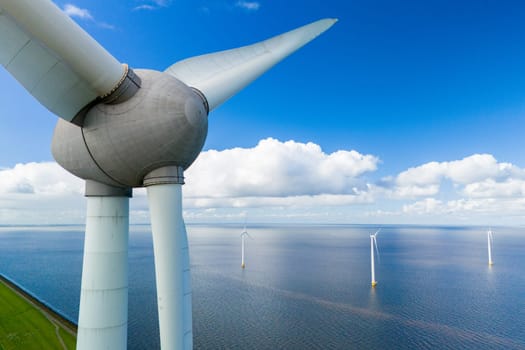 A single wind turbine stands tall in the middle of a large body of water, harnessing energy from the wind to generate electricity in the Noordoostpolder Netherlands, windmill turbines in the ocean