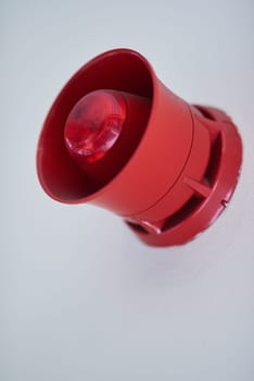 Emergency, siren and red speaker for fire alarm, warning and evacuation with safety regulations or compliance. Light on wall for security alert, noise and danger with sound, electricity and risk.