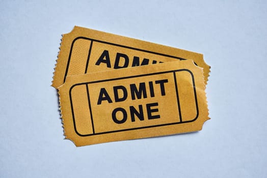 Cinema, entertainment and movie ticket against white background for date night, fun and admission. Paper, token and theatre customer proof of payment for film, show or artistic stage performance.