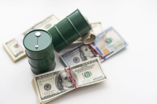 barrels of oil standing on the dollar bills of money. the oil business, purchase sale, production, exchange, trading income. High quality photo