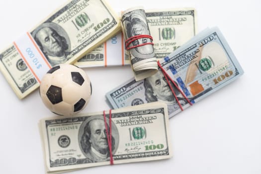 soccer ball over a lot of money. corruption football game. Betting and gambling concept. wold cup. High quality photo