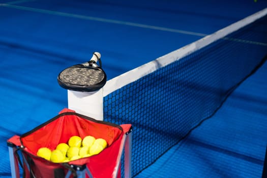 Paddle ball on racket. Yellow paddle ball laying near racket. High quality photo