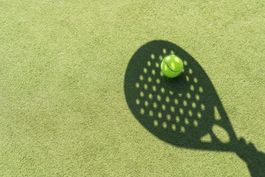 Paddle tennis racket shadow on balls. High quality photo