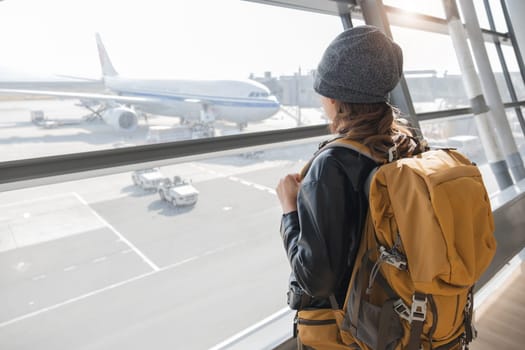 A woman wearing a black jacket in airport.