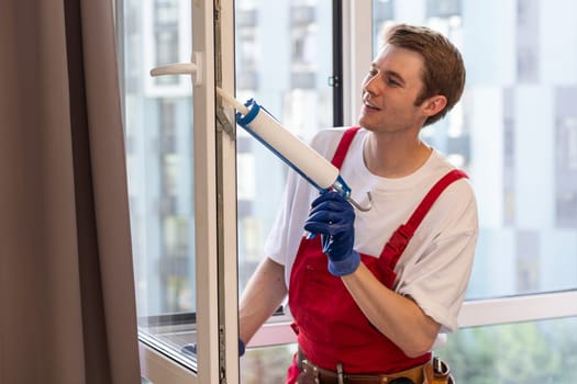 A repairman fixing windows in new apartment.