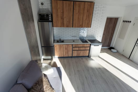 Modern living room and kitchen in small apartment.