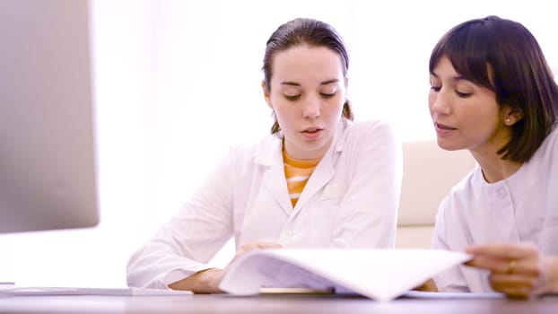 Two female doctor consulting a medical inform in the clinic